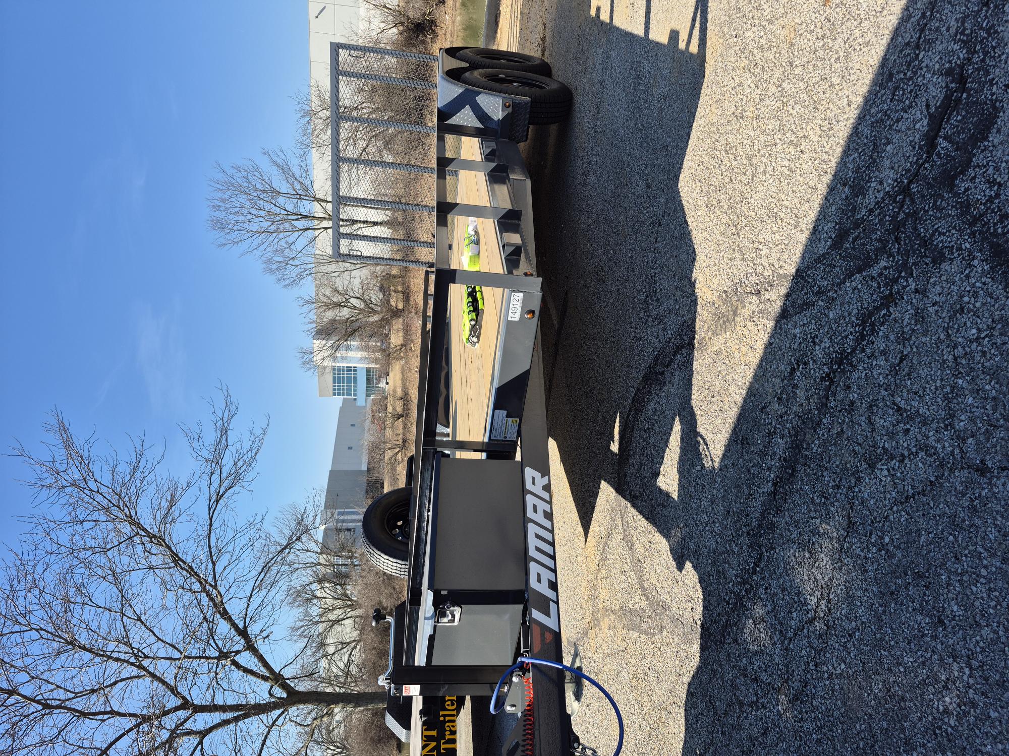 Lamar 7x16 utility trailer full side profile showing wood deck and mesh headboard for rent in Greenfield, IN